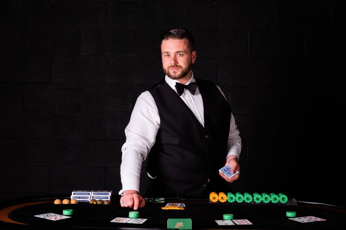 A casino magician running a rigged casino table for guests at a corporate event