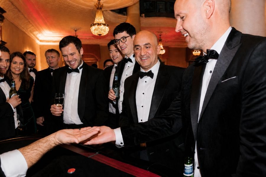 A large crowd gathered around a casino magician