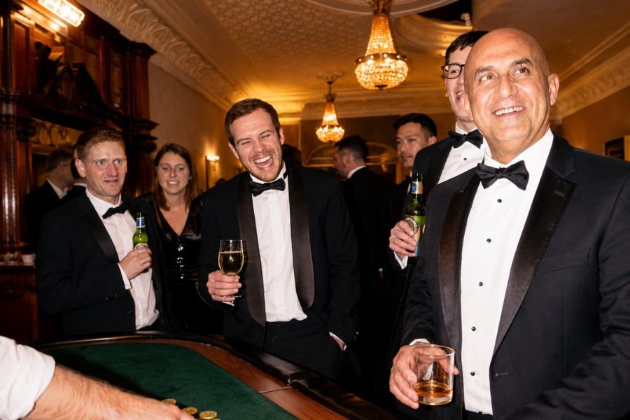 Guests reacting to a casino magician's con at a corporate event