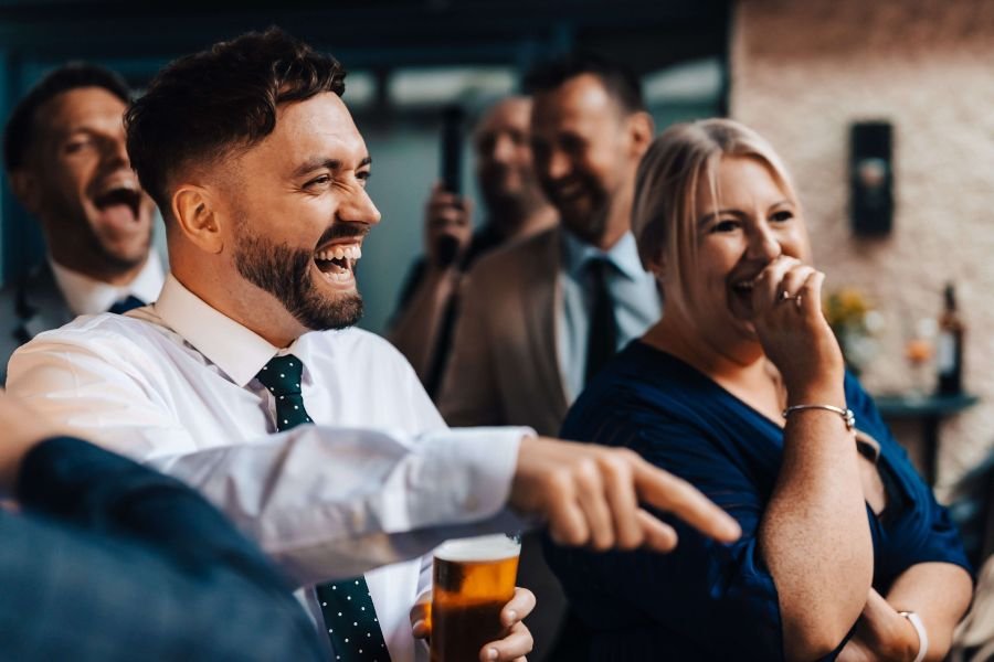 Guests laughing at a casino magician's rigged game