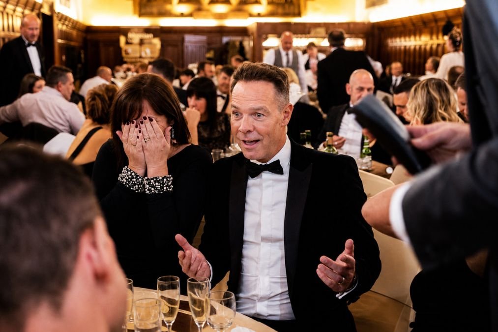 A magician performing close-up for corporate guests