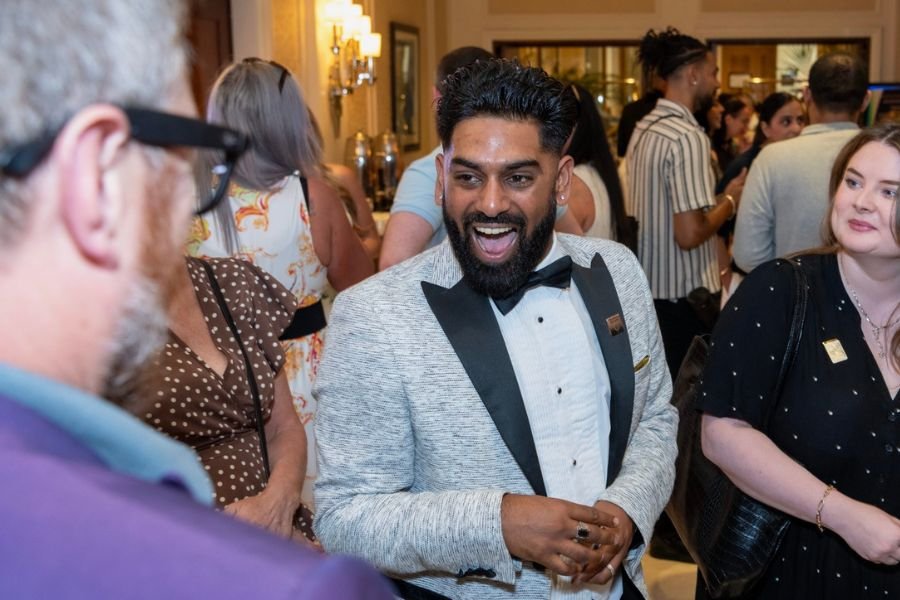 A guest astonished as a mentalist reveals their thought at a corporate event