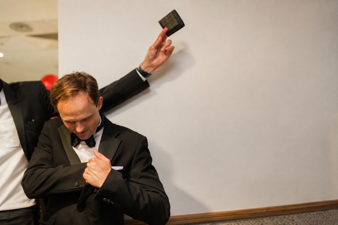 A guest astonished by a pickpocket magician at an awards evening