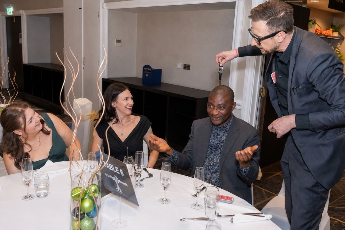 A pickpocket magician working a group at a drinks reception