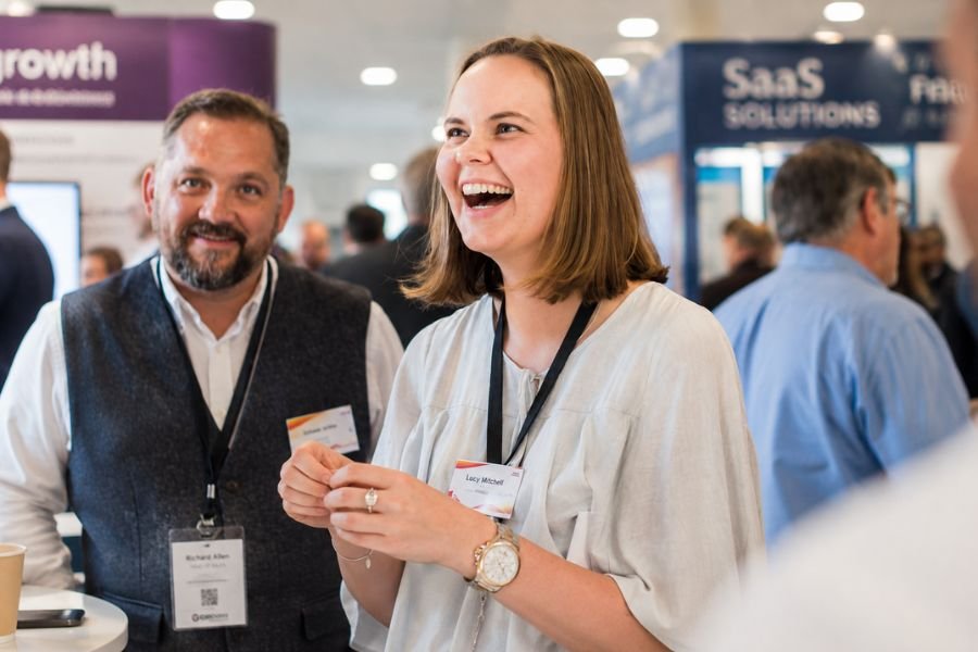 A crowd of visitors watching a trade show magician on a corporate stand