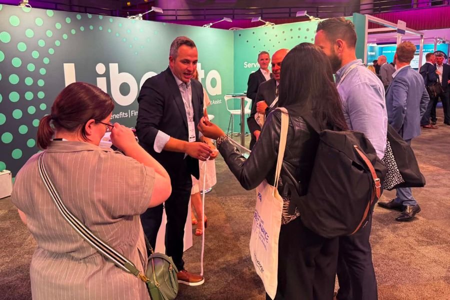 A trade show magician performing close-up magic for delegates