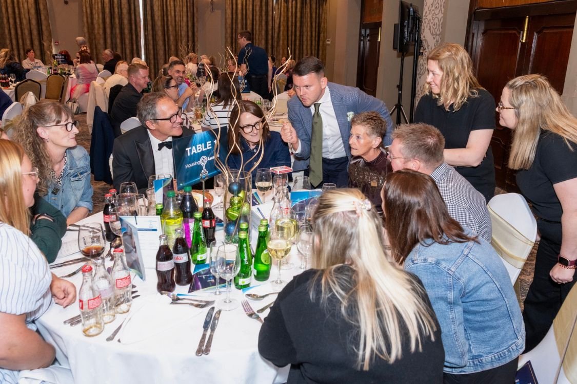 A table magician performing for guests at an awards dinner