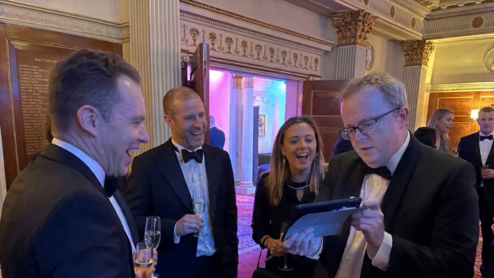 A tech magician performing a digital illusion for guests at a corporate event